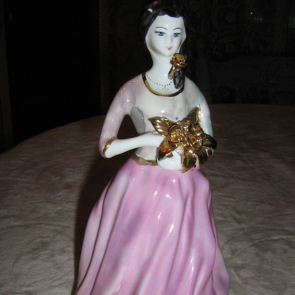 Lady In A Pink Dress Carrying Flowers